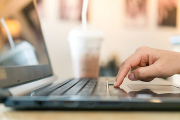 Woman hand using laptop to work study on work desk with clean nature background background. Business, financial, trade stock maket and social network.