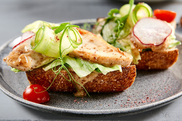 Bruschetta with turkey in nut sauce in gray plate