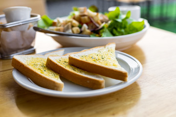 Tasty bread with garlic  on kitchen table.