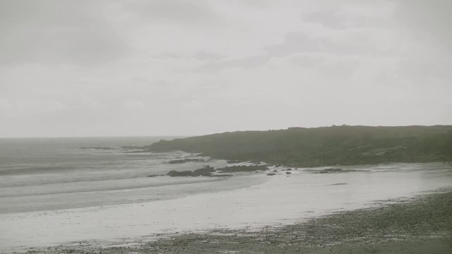 Calm Waves Crashing Onto Kersidan Beach On Misty Day. Slow Motion 