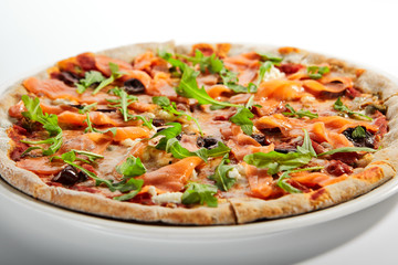 Sliced pizza with salmon, calamata olives and sun dried tomatoes