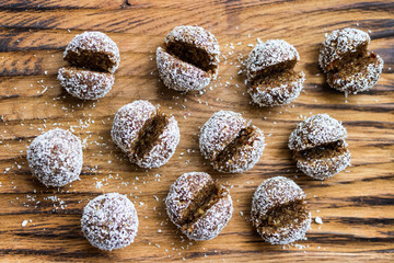 Obraz na płótnie Canvas Sweet coconut chocolate truffles energy bonbon balls. Vegan healthy dessert food.
