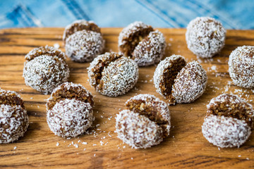 Fototapeta na wymiar Sweet coconut chocolate truffles energy bonbon balls. Vegan healthy dessert food.