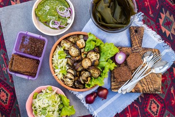 Grilled, roasted eggplant vegetables, salad, bread. Vegan food lunch. Overhead, flat lay