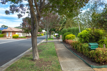 Pedestrian sidewalk/footpath in an Australian suburban neighborhood. Typical street view in a...