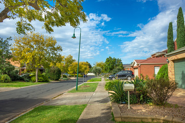 Pedestrian sidewalk/footpath in an Australian suburban neighborhood. Typical street view in a residential suburb. Melbourne, VIC Australia.