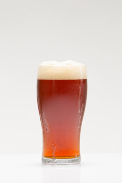 Amber Ale Beer in Ice-cold Glass with Head - Photographed on White in Studio