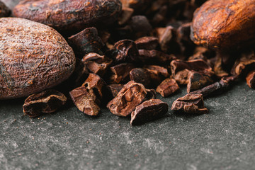 Dark chocolate pieces crushed and cocoa beans, top view