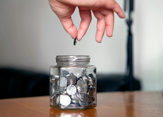 Fototapeta na wymiar Glass jar with coins
