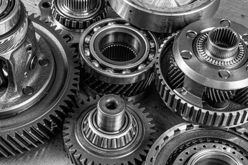 Close-up of a car gearbox. Metallic shiny gears for planetary gearshift. Industrial metal gears for...