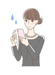 スマホを操作して不安な女性