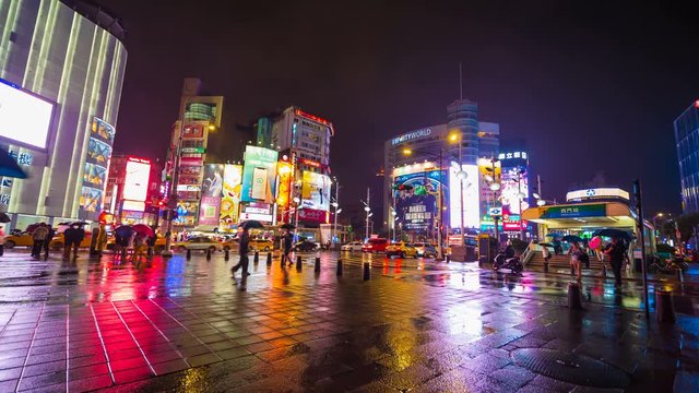 4k Time-lapse of Traffic on road with falling rain in Ximen district at night, Taipei, Taiwan