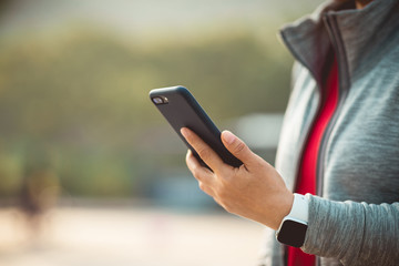 Asian woman using smartphone outdoors