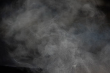 Close-up fog or smoke on a dark background, backdrop