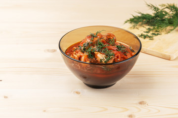 Chakhokhbili of chickens on a wooden table. National Georgian dish.