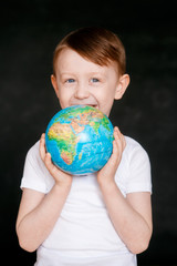 Face of a mask-wearing boy with fear in the eye Close-up on a gray background. Coronavirus and Air pollution concept. COVID-19 child on black background.