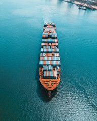 Container ship carries cargo, goods, and materials from one port to another for supplying purpose. - obrazy, fototapety, plakaty