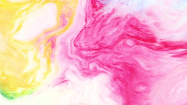 Pink and yellow milk interfere with white paint. Dilution of multi-colored paint colors on a white background. Bright abstract textures and stains of thick fluid mix in the paint for the designer.