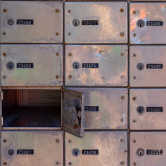 mailboxes with serial numbers with one door open.