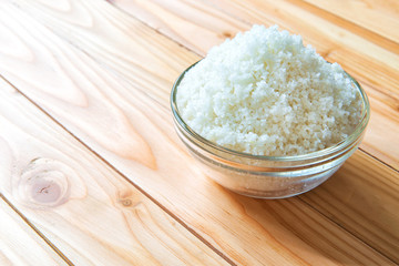 Sea salt in bowl on wooden background, Sea salt is salt that is produced by the evaporation of seawater. Used as a seasoning in foods, cooking, cosmetics and for preserving food..