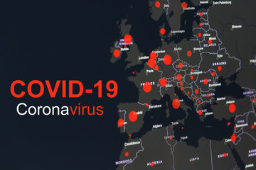 The coronavirus pandemic with the word COVID-19 on the global map of Europe with red dots of infection centers.