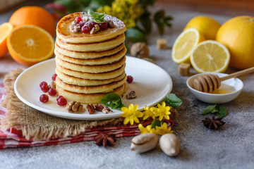Delicious fresh beautiful pancakes with citrus honey and jam
