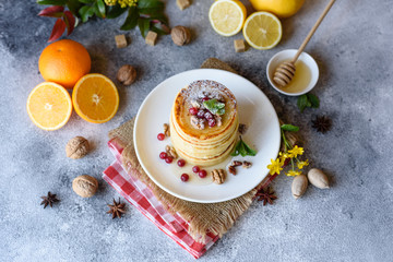 Delicious fresh beautiful pancakes with citrus honey and jam