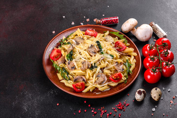 Pasta with mushrooms, cheese, spinach, rukkola and cherry tomatoes