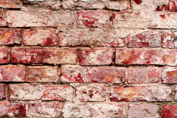 Texture of a brick wall with cracks and scratches which can be used as a background