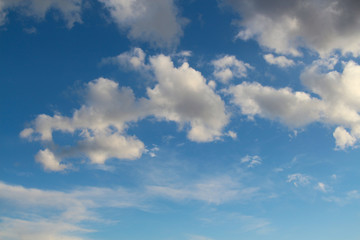 Beautiful blue sky before sunset. Cumulus clouds flies in the air. Beautiful landscape. Theme of weather forecast.