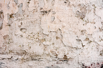 Texture of a concrete wall with cracks and scratches which can be used as a background
