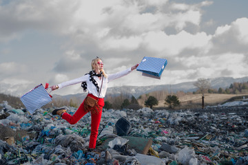 Modern woman on landfill, consumerism versus pollution concept. - obrazy, fototapety, plakaty