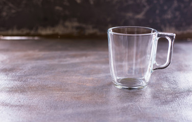 A glass cup for tea and coffee is on the table.