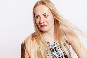 Beautiful surprised blond woman. Sincere emotion. White background.