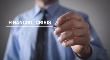 Man writing Financial Crisis text in screen.