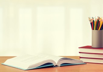Stack school books with color pencil on desk