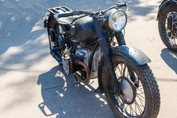 Old motorcycle parked on a city street