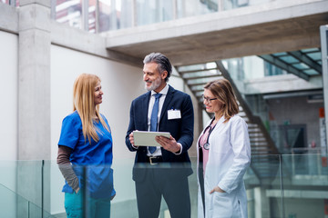 Group of doctors talking to pharmaceutical sales representative.
