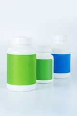 Three bottles of vitamins in one row