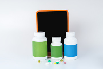 Three bottles of medicla supplements next to the smartphone