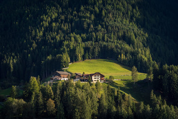 A house on the side of a mountain hill with surrounding forest and countryside in the town of San...