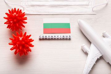 Plane model and face mask and flag Bulgaria. Coronavirus pandemic. Flight ban and closed borders for tourists and travelers with coronavirus covid-19 from Europe and Asia.