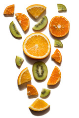abstract slicing of fruit tangerines with oranges and kiwis on a white background
