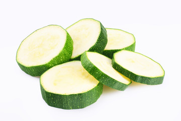 fresh green zucchini slices isolated on white background