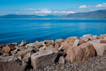 bay fjord bay in reykjavik and beautiful view of the ocean on a sunny day through the stones