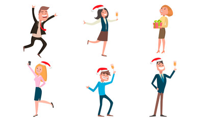 Smiling office workers in traditional red hats celebrating Christmas or New Year