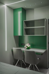 It  is an study table make for children with an comfortable chair with the colour combination of green and grey under warm light  shoot for my customer at banglore  