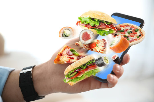 Man Using Smartphone For Ordering Food Online, Closeup. Delivery Service During Quarantine