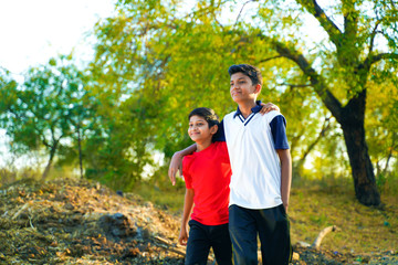 two little indian brother walking on road
