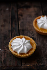 lemon cheesecake pie on wooden background with flower petals